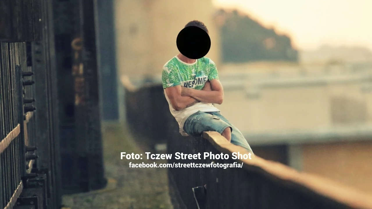 Młody mężczyzna wszedł na Most Tczewski i usiadł na barierkach...