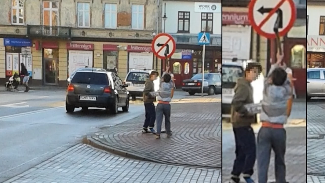 Małolat siekierą niszczy znak